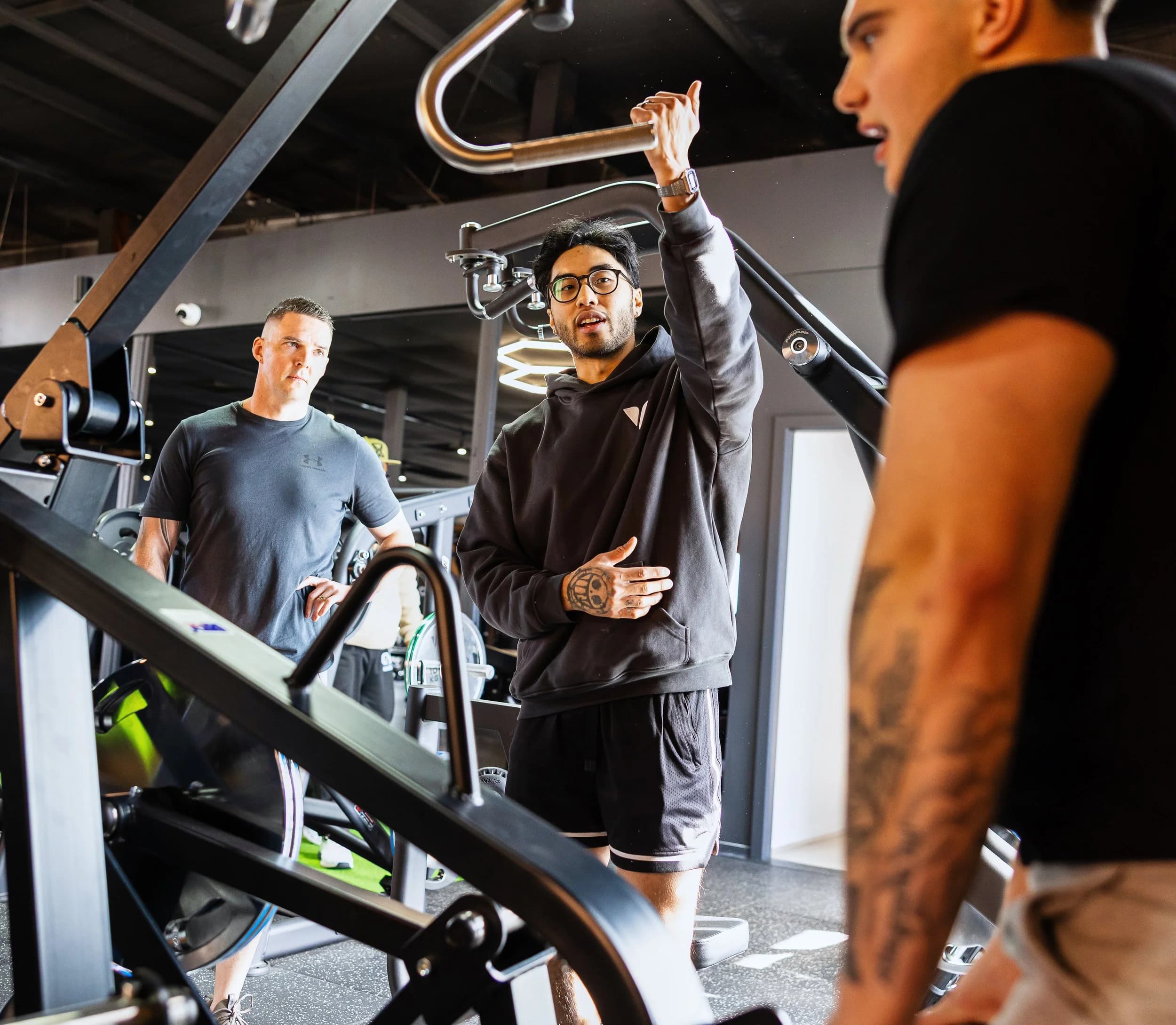 Coaching a client through a movement on the gym floor